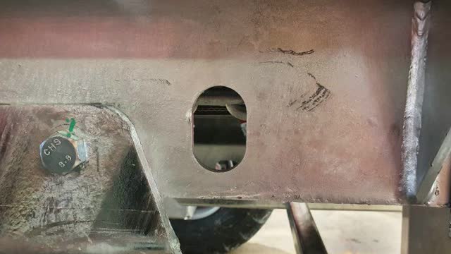 <p>Check tension by looking through chain tension indicators on rear of machine. A correctly tensioned chain/belt will have the chain link sitting near the middle of the slot.</p>