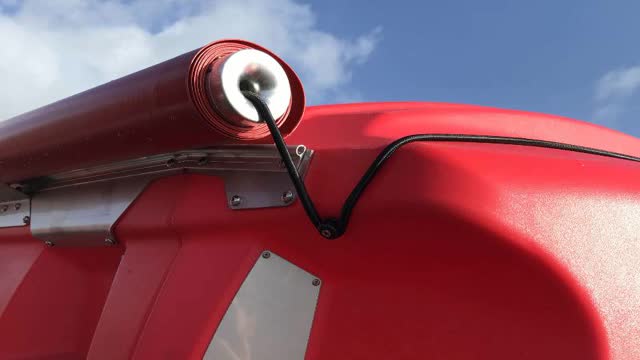 <p>The rolled up cover is held in place when open by hooking the bungee cord around the retaining lug.</p>