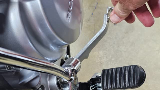 <p>Push the rear brake pedal down and move the bike forward or backward to feel good brake engagement
If its not working correct, adjust the rear brake at the brake pads adjuster</p>