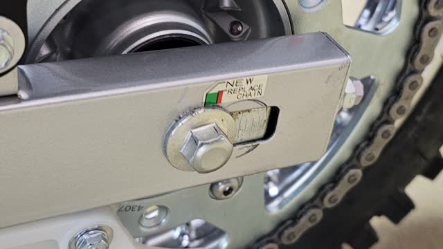 <p>If the chain is too tight or too loose, adjust by loosening the rear nuts on either side of the swing arms, loosen the rear axle bolt,
Then pull the rear wheel backwards by turning the nuts at the back of the swing arms inward, the chain will tighten,
Then lock the rear axle bolts and the nuts</p>
