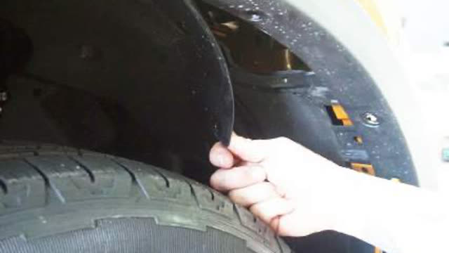 <p>Under the inner guard there are inspection
ports. Remove the three (3) clips and twist the
guard out of the way to access the bolts and
clips behind securing the factory bumper to
the guard.</p>
<p>Repeat procedure on opposite side.</p>