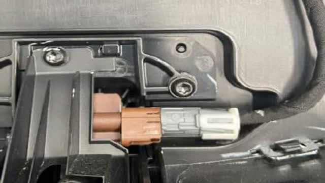 <p>If applicable, carefully remove the camera from behind the grille, making sure not to drop it.
Remove wiring and water hose.</p>