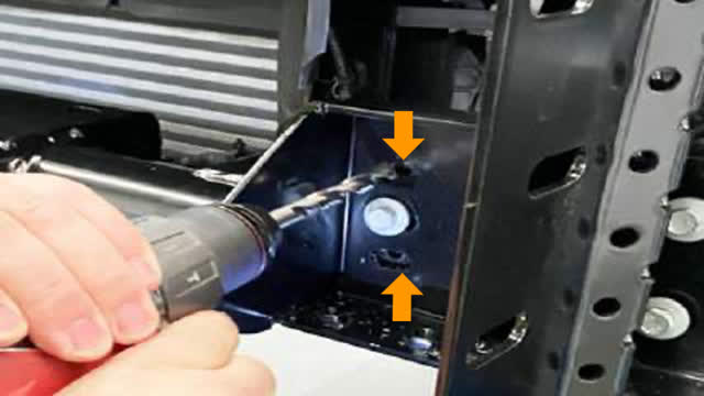 <p>On the Right Hand Side of the vehicle:
Drill the two (2) existing holes out to 10mm.
Deburr and paint.
Use the remaining cradle hardware through
these drilled holes and finger tighten only.</p>