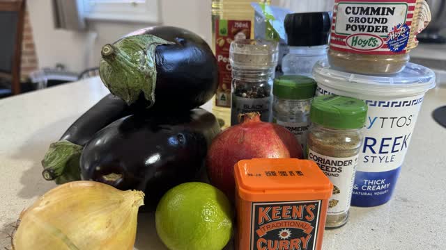 <p><strong>Ingredients:</strong></p>
<ul>
<li>large aubergines (3) (approximately 1.1 kg)</li>
<li>Peanut oil (100ml)</li>
<li>Greek style yoghurt (200g)</li>
<li>Curry powder (2 teaspoons)</li>
<li>Ground Turmeric (1/4 teaspoon)</li>
<li>Lime (1)</li>
<li>Brown onion (1)</li>
<li>Flaked almonds (4 tablespoons)</li>
<li>Cumin seeds (1/2 teaspoon)</li>
<li>Coriander seeds (1/2 teaspoon)</li>
<li>Pomegranate seeds (40g)</li>
<li>Salt and pepper</li>
</ul>