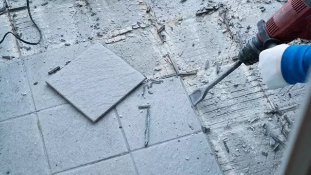 <p>Place a scraper in the joint between the tiles.</p>