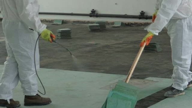 <p>Spray water under the flooring as you lift it up, to suppress dust.</p>