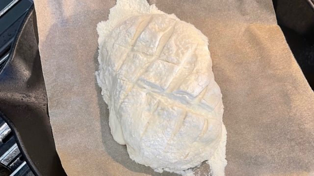<p>Place the dough in the fridge for ten to fifteen minutes then make quick slashes across its surface to allow the dough to expand when it’s placed in the oven.</p>
<p>Sprinkle the top lightly with flour.</p>