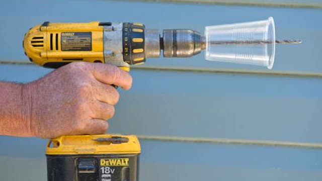 <p>Pre-drill a transparent plastic cup (or polystyrene cup) with the same drill that will be used on the ACM and fit onto the drill bit. Place the drill bit through the cup, with the bit towards the top of the cup and extending beyond the cup (drill with hand drill or low-speed battery powered drill).</p>