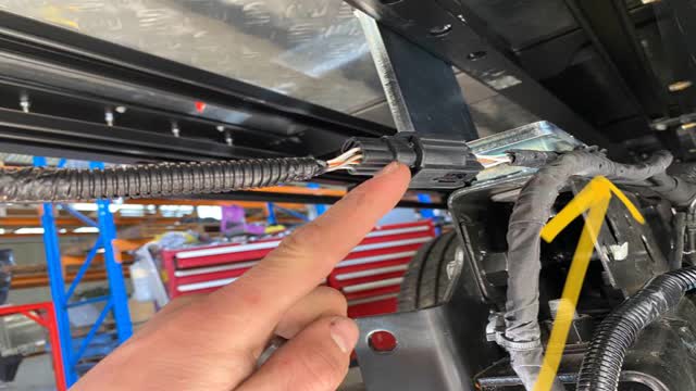 <p>Plug in the sensor harness to vehicle.</p>
<p>TIP: So that the harness can reach, it is necessary to cut some of the zip ties holding the vehicle harness to the vehicle chassis - by doing this the harness can come back further.</p>
