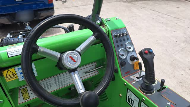 <p>The park brake lever is on the lower right hand side of the panel in fron of the driver. Pull out and turn counter-clockwise to engage. Reverse this manoeuvre to release.</p>
