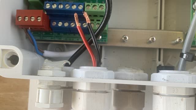 <p>Feed the wires through the base.
Remember to silicone seal once you are finished.</p>