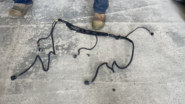 <p>Remove OEM tail light harness from rear cross member.</p>