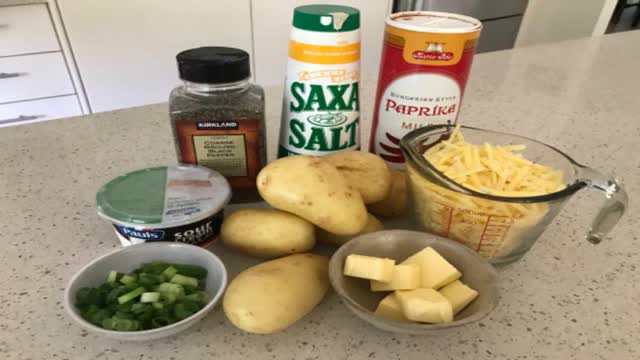 <p>Ingredients:</p>
<p>6 medium potatoes
2 c shredded chedder cheese
1/4 c butter
1 1/2 c sour cream
1/3 c finely chopped green onion
1 tsp salt
1/4 tsp pepper
2 Tbl butter (extra)
Paprika</p>