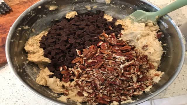 <p>Stir in chocolate chips and nuts. Seems like a lot I know but it makes the most delicious cookies with plenty of chocolate goodness!</p>