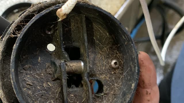 <p>Insert the string from the smaller hole.</p>