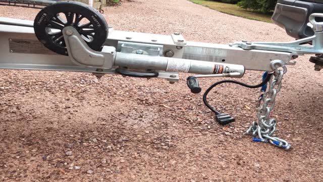<p>Secure the jack - on this trailer the wheel is stored facing up not down. Ensure the jack is locked into place and isn't loose that it can end up dragging on the ground.</p>