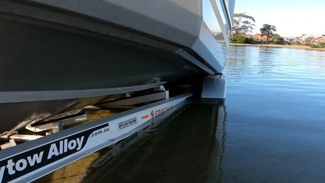 <p>This boat launches well when the water is about 1/2 way up the guards. To shallow and your prop might hit the ground. To deep and the boat can float off the trailer</p>