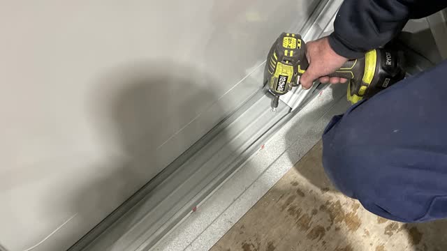 <p>Screw off the third wall frame to the floor using two screws per bay.</p>
