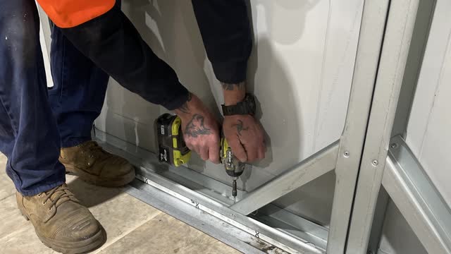 <p>Screw the second wall frame off to the floor using two tech screws per bay.</p>
