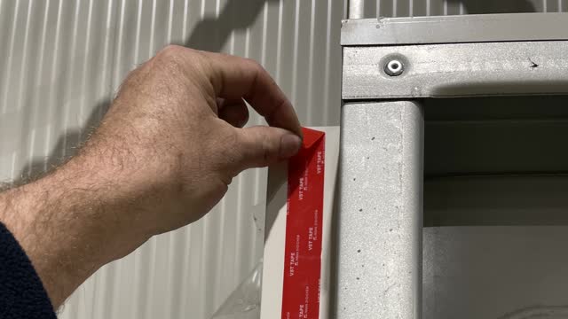 <p>Peel double sided tape on flange of wall.</p>
