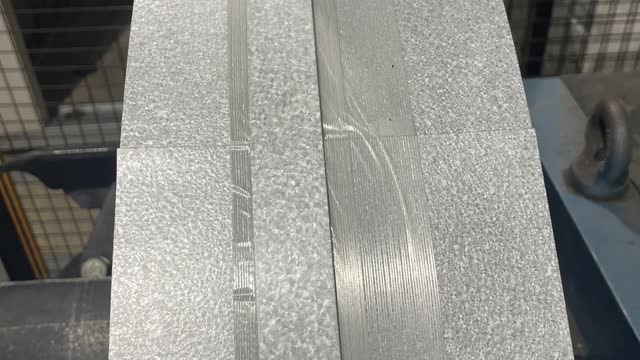 <p>Cut the metal strap and tape with a grinder, make sure to hold the coil end, so it doesn’t hit you when unwrapped.</p>