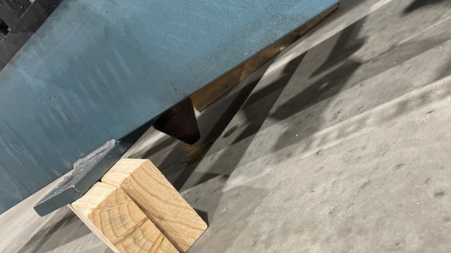 <p>Place the wood up on its side, on either side of the cone.</p>