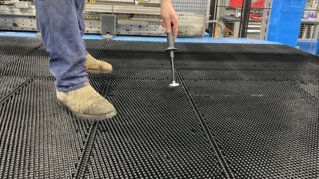 <p>Using a magnet, pick up all the small pieces of metal on the feed table.</p>