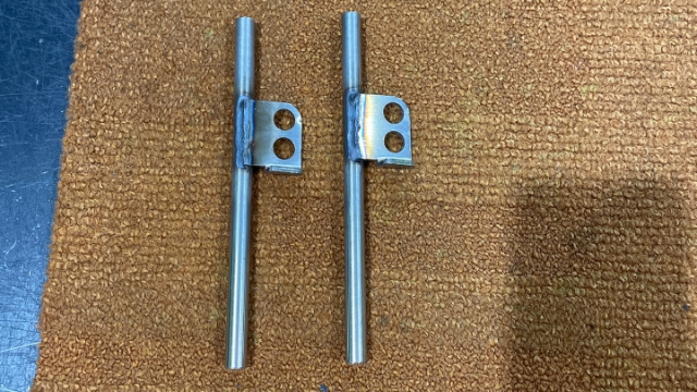 <p>Roller Door Latch: After Rods and Tabs have been welded, they need to be cleaned in the Acid bath. [photo; Latches before an acid bath.]</p>
