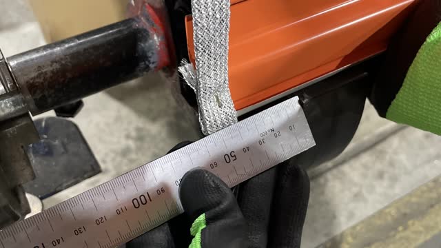 <p>While still holding the door with one hand, use the other hand to grab the ruler, use the ruler to make sure both sides are an even distance off the door, make sure to talk to the other roller so you can do this.</p>