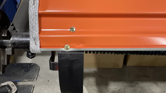 <p>Using the drill, screw in two screws, securing the door to the wheels, then take off the clamps. make sure to do all 3 wheels.</p>