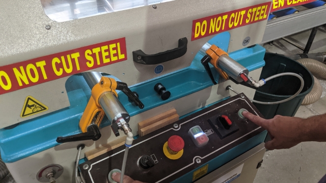 <p>Push down both green buttons at once to cut.</p>