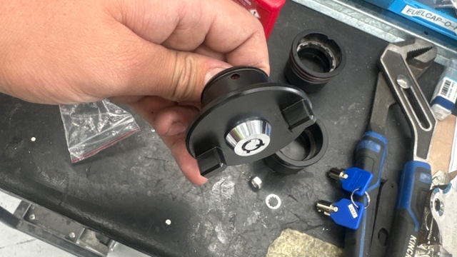 <p>Place lock barrel into top half of fuel cap ensure the 2 lines on the lockbarrel face away from the hole (Pac-Man doesn’t want to eat the ball)</p>