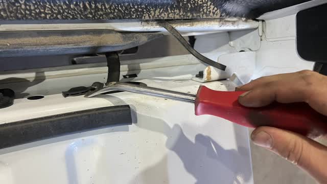 <p>Use removal tool, drivers side of tailgate</p>