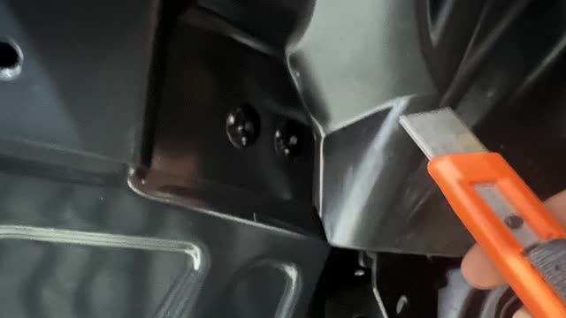 <p>Use a sharp knife to cut the plastic inner guard around the rivets</p>